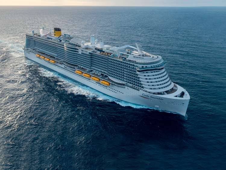 A large ship, part of the Costa Cruises fleet, sails a wide open ocean.