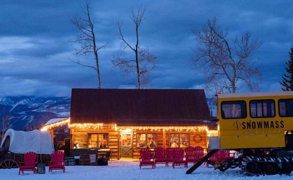 A snowcat sits alongside Lynn Britt Cabin near Snowmass.