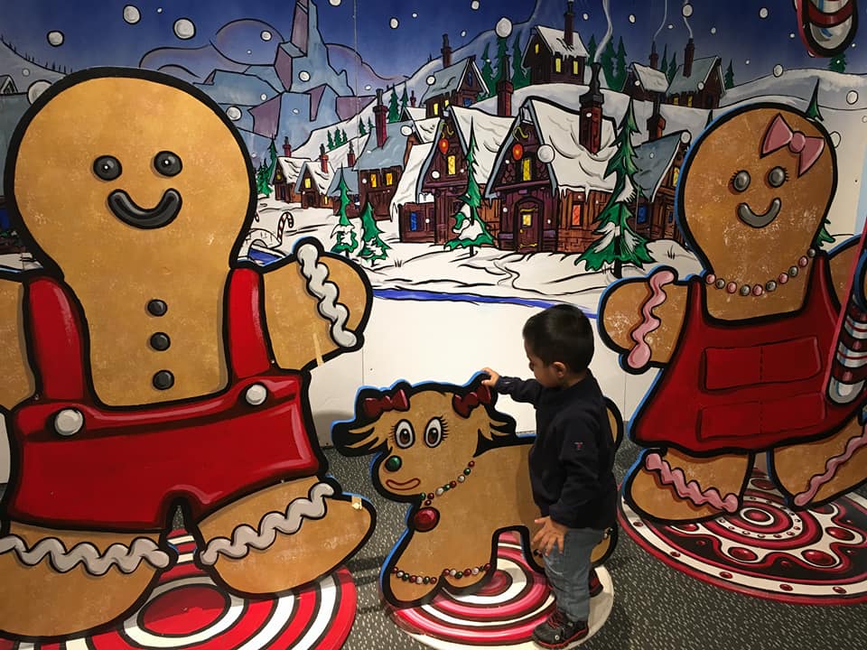 A young boy plays at a ginger bread exhibit at the New York Hall Of Science.