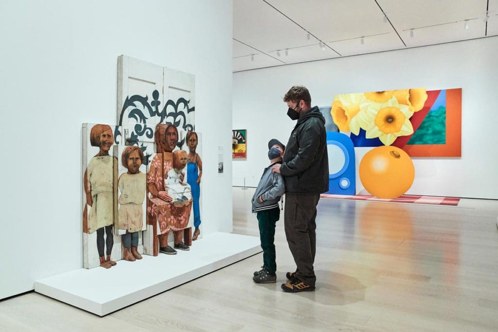 A dad and his young son look at an art piece at MoMa, one of the best museums in New York City for kids.