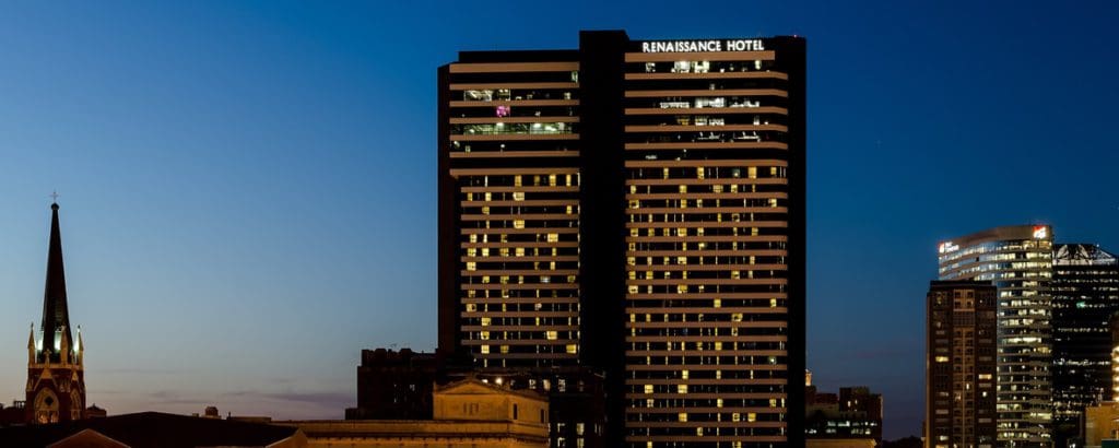 The Renaissance Nashville Hotel rises above surrounding buildings on the Nashville skyline at night.