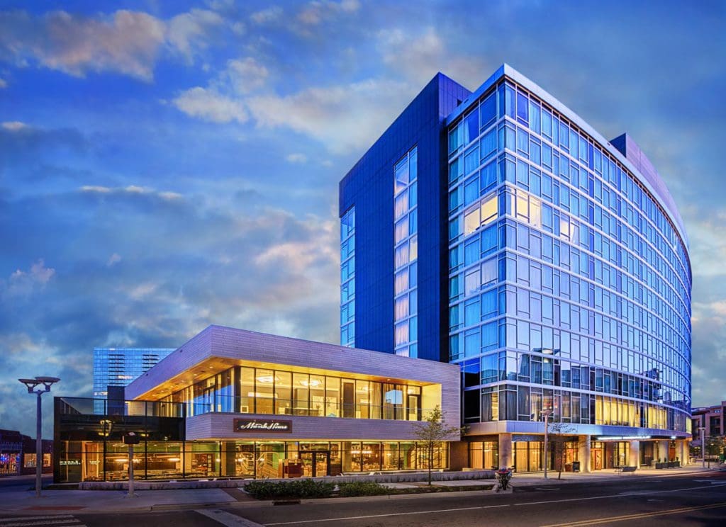 A view of the Thompson Nashville exterior and entrance on a sunny day.