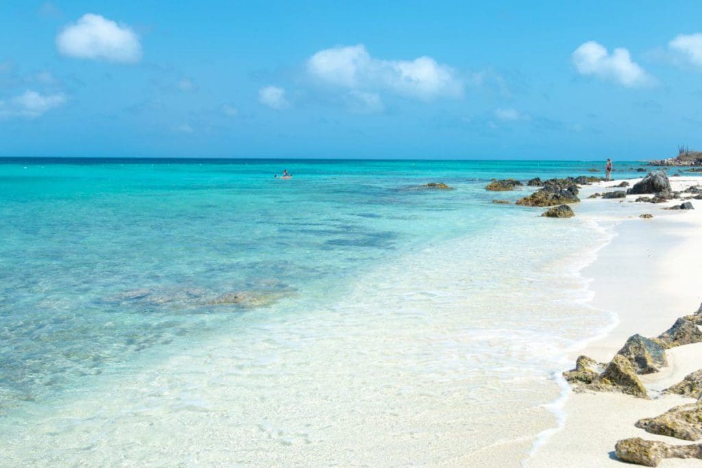 A view of Boca Catalina beach in Aruba, featuring white sand and turquoise waters, one of the best beaches in Aruba for families.