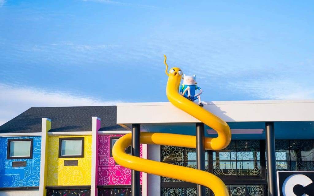 The outside of the colorful Cartoon Network Hotel, featuring a fun, cartoon slide at one of the best themed hotels on the East Coast for families.