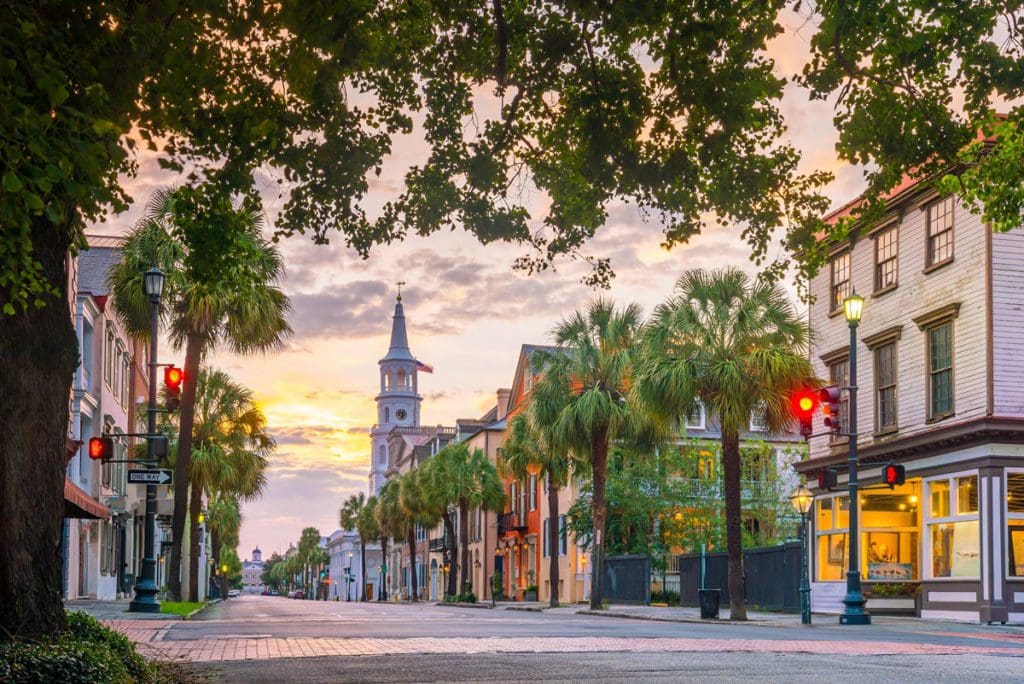 The main street in Charleston, South Carolina, with a large church at the end of the street, at dusk, one of the best places to travel with your mom.