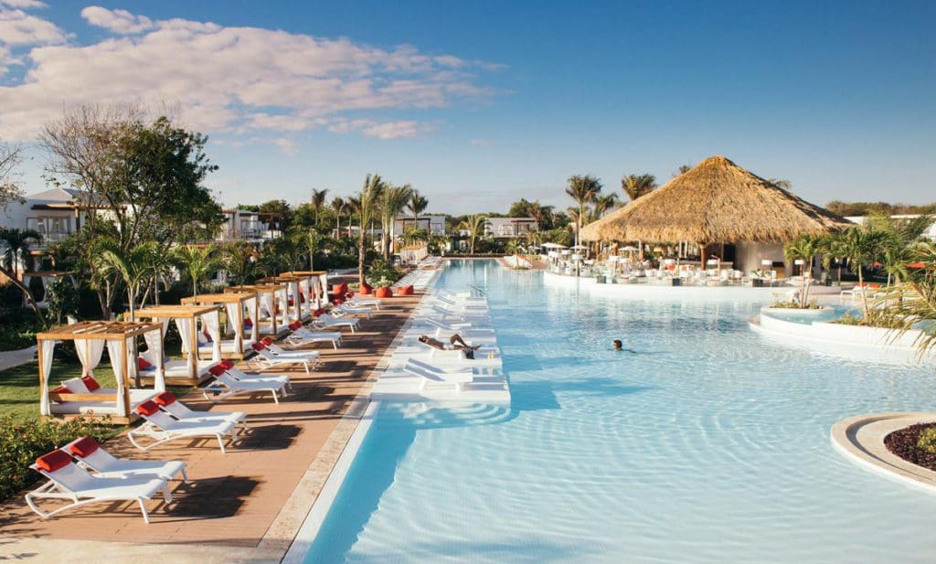 A line of poolside loungers near a tranquil pool at Club Med Punta Cana.