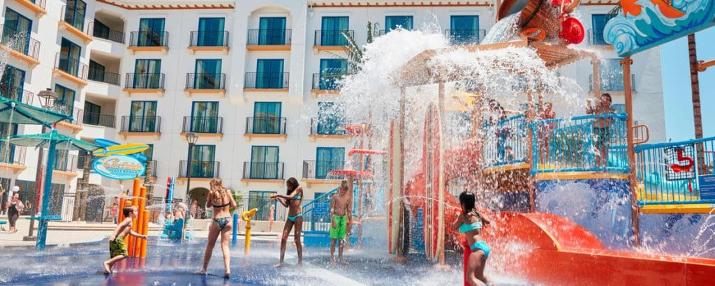 Several kids play at the colorful splash pad at Courtyard by Marriott Anaheim Theme Park Entrance, one of the Best Marriott Properties in the U.S. for a Family Vacation.