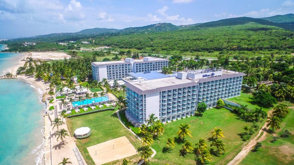 An aerial view of the grounds and beach of the Hilton Rose Hall Resort & Spa, one of the best all-inclusive resorts in Jamaica for families.