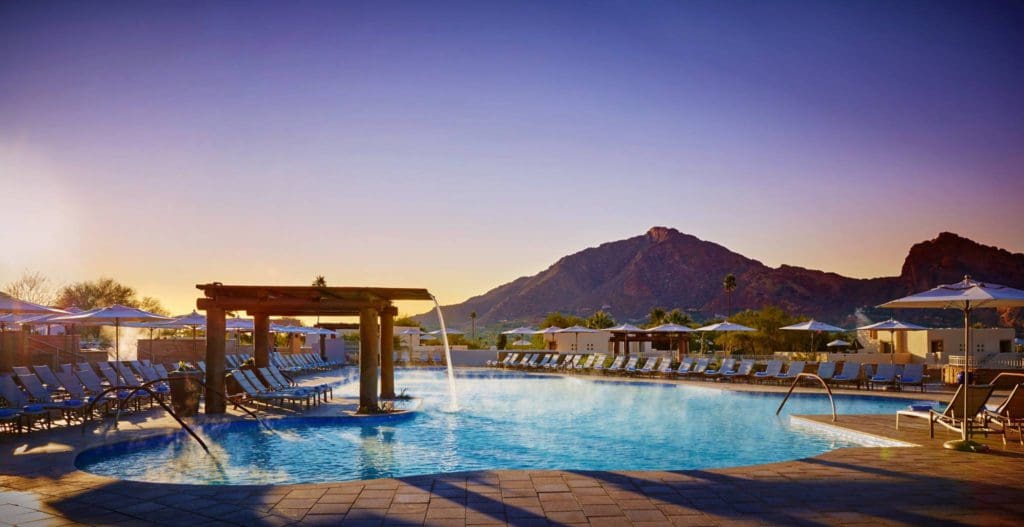 The stunning pool, with cascading water, at JW Marriott Scottsdale Camelback Inn Resort & Spa during twilight, at one of the Best Marriott Properties in the U.S. for a Family Vacation.