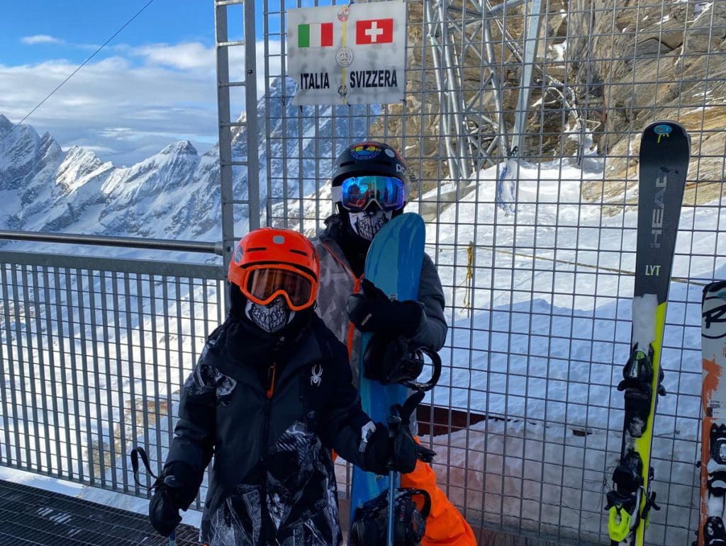 Two boys ski on the Italian side of the trails near Zermatt, one of the best places to ski Europe with Kids.