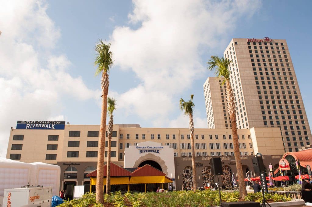 The exterior of Hilton New Orleans Riverside, featuring large resort buildings at one of the best hotels in New Orleans for families.