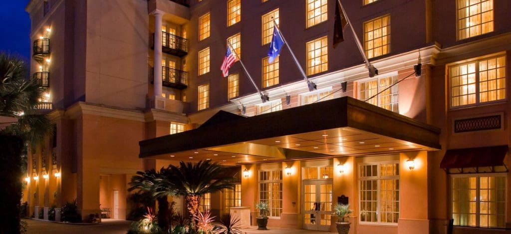 The grand entrance to The Renaissance Charleston Historic District Hotel, lit up at night.