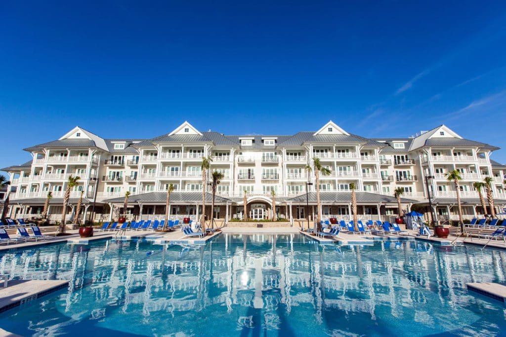 A view of the The Beach Club at Charleston Harbor Resort and Marina resort buildings behind its massive outdoor pool.
