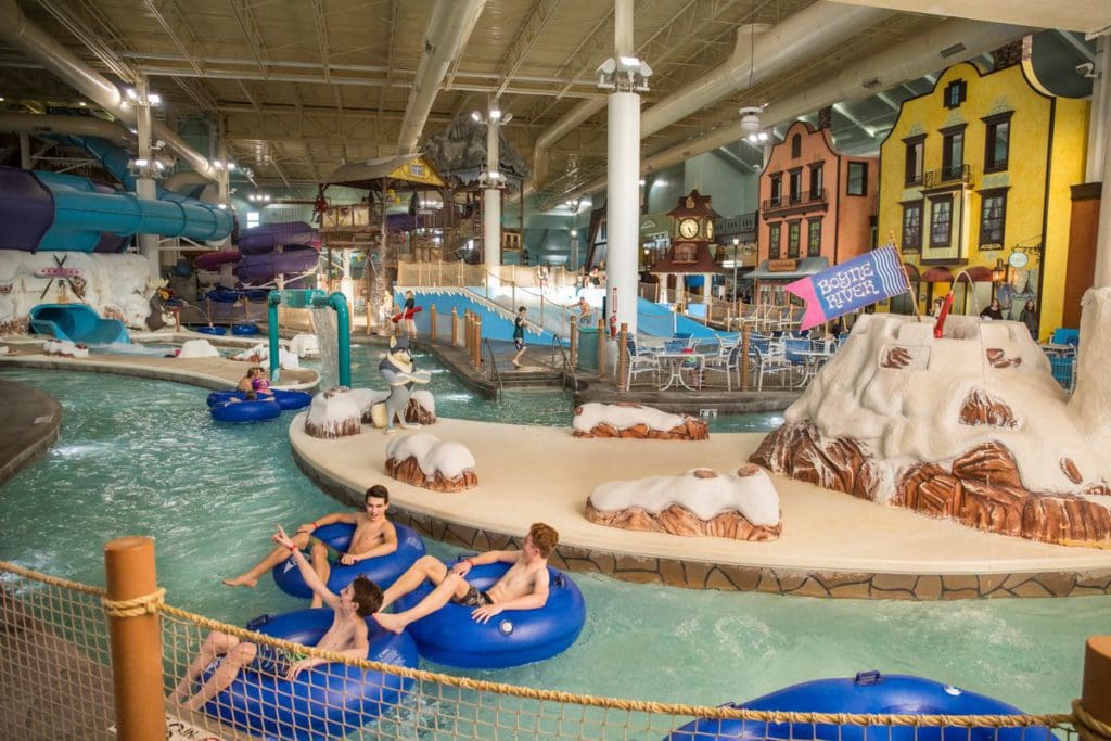 Three people in blue innertubes float down the lazy river at the indoor water park at Boyne Mountain Resort.