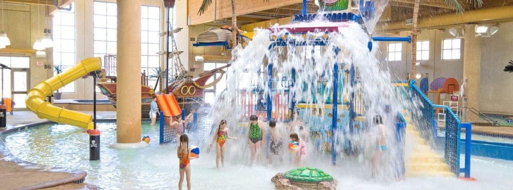 Several kids splash amongst the splash zones at Bridges Bay Resort's indoor water park.