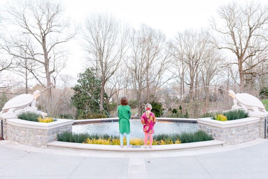 Two kids admire a fountain at Visit the Cheekwood Estate and Gardens.