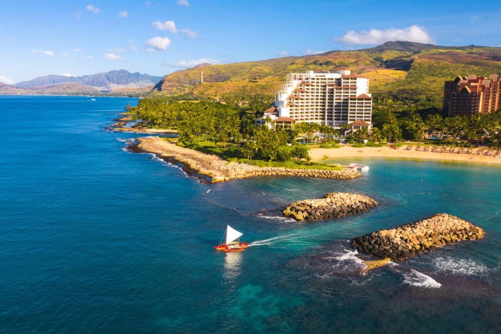 An arial view of Four Seasons Resort O'ahu Ko Olina, featuring a sprawling beach and lush resort grounds at one of the best luxury hotels in the U.S for families.
