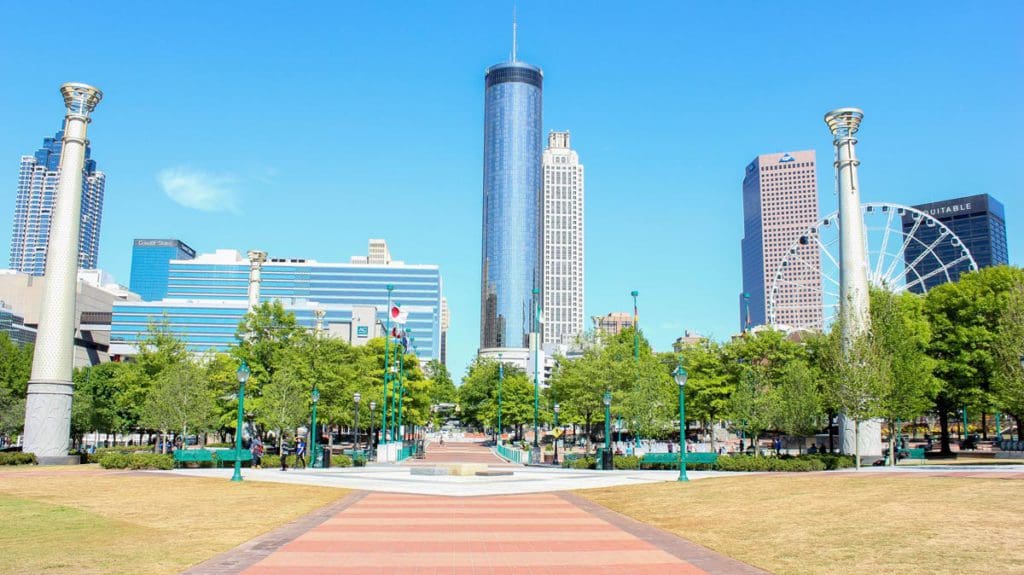 A view of Olympic Park in Atlanta, featuring large grounds and a view of the downtown skyline.