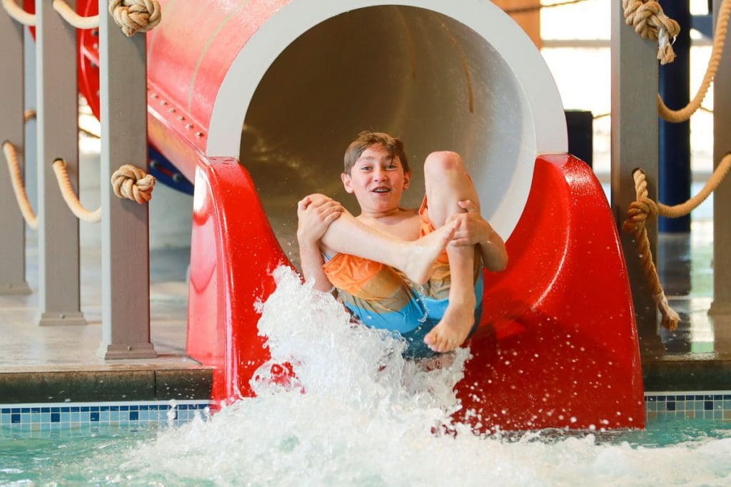 A young boy slides down a large water slide at Grand View Lodge Spa & Golf Resort.