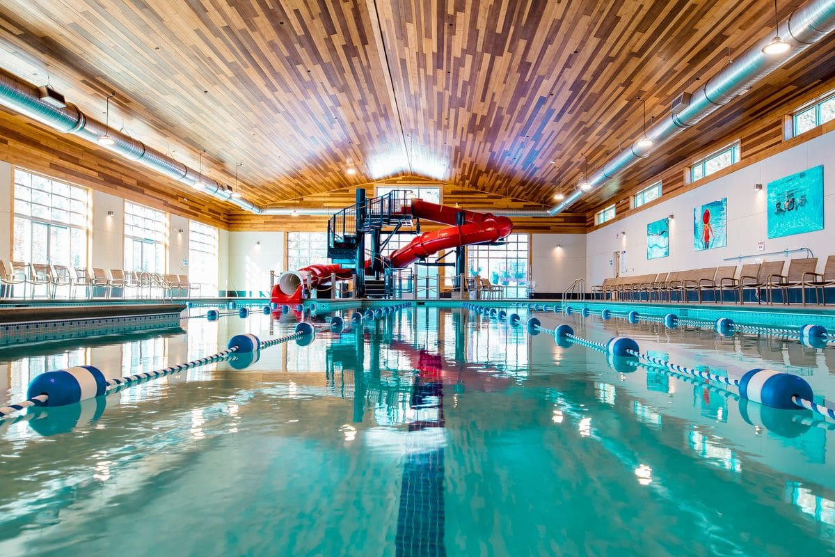 Inside the indoor water park at Grand View Lodge Spa & Golf Resort, featuring a large pool and large red slide.