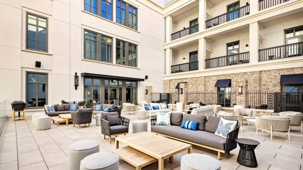 The outdoor patio at Liberty Place Charleston by Hilton Club, featuring plush seating.