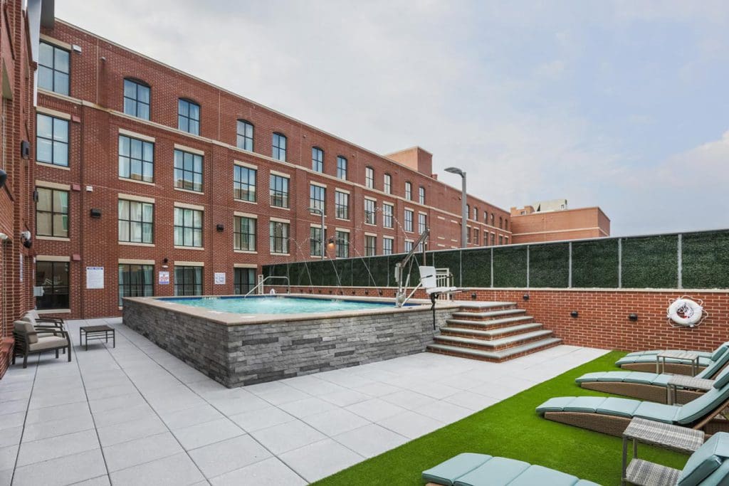 The outdoor pool at Homewood Suites by Hilton Charleston Historic District, with hotel buildings behind it.