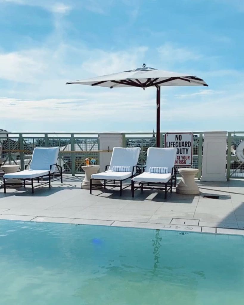 The outdoor pool at Hotel Bennett, with a view of Charleston over the balcony.