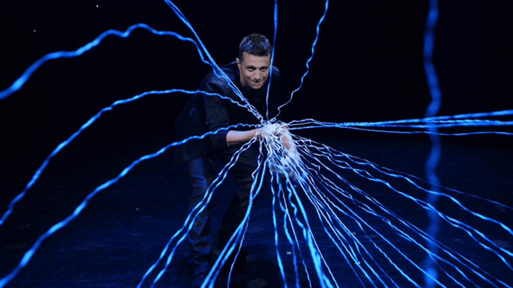 Performer, Mat Franco, stands behind a magic display during his show at the LINQ Hotel in Las Vegas, one of the best things to do in Las Vegas with kids.