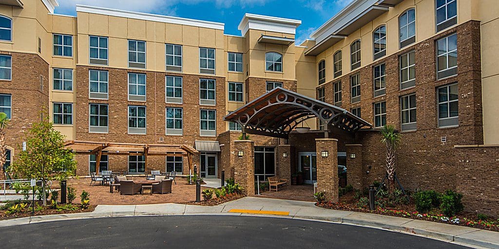 The entrance to Staybridge Suites Charleston - Mount Pleasant, an IHG Hotel on a bright, sunny day.