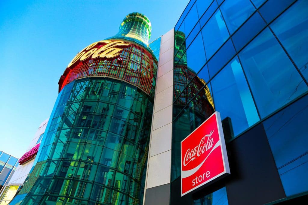 A large bottle of Coke display on the side of the Coca-Cola store building in Las Vegas, one of the best things to do in Las Vegas with kids.