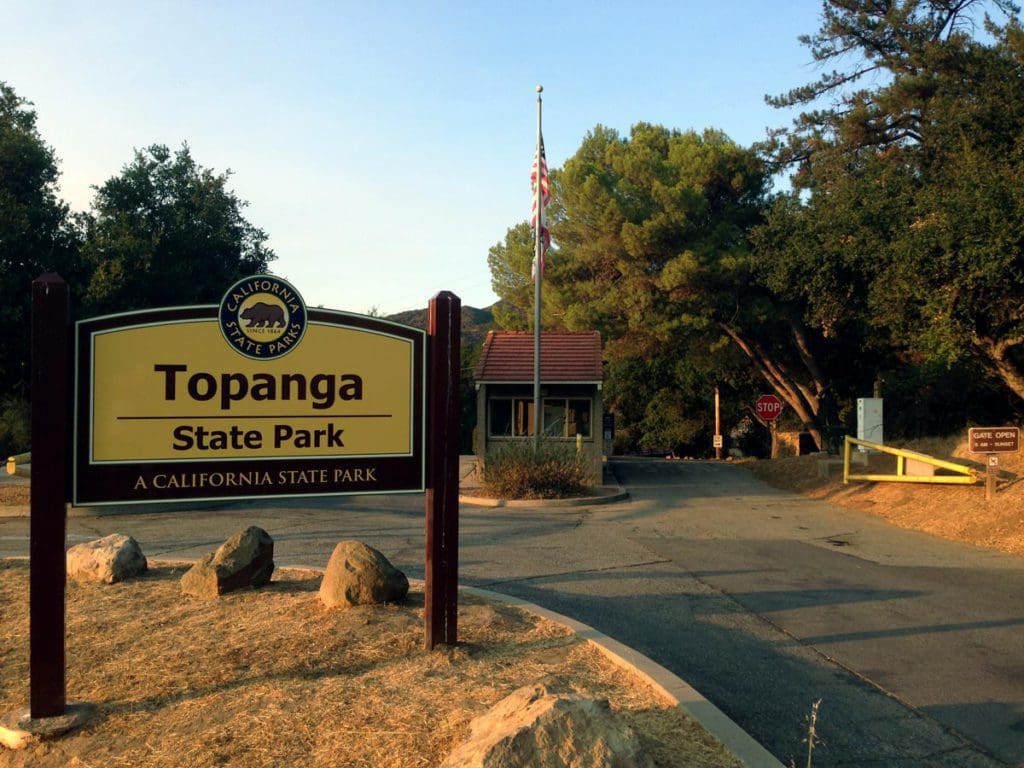 The entrance sign to Topanga State Park, with the Visitor's Center down the drive way from the sign. Hiking is one of the best things to do in Los Angeles with teens this summer.