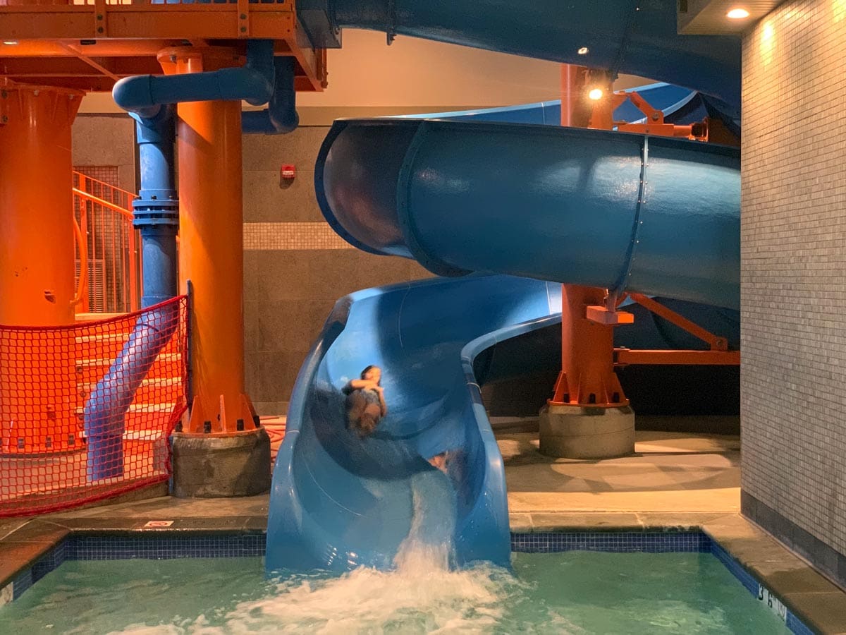 A young boy shoots down the large waterslide at Woodloch Resort.