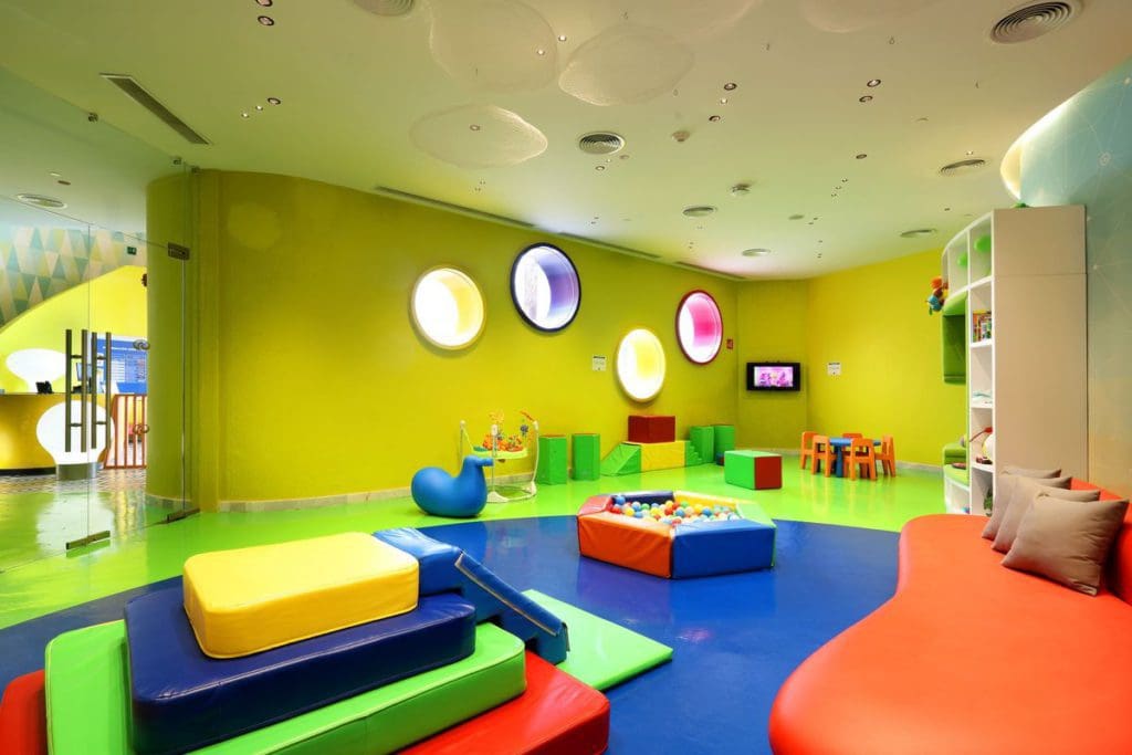 Inside the colorful kids' club room at Grand Palladium Costa Mujeres Resort & Spa, featuring plenty of places to play, color, and have fun.