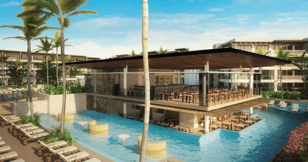 The restaurant at Royalton Riviera Cancun, located in the middle of an intimate pool, with surrounding resort buildings at Royalton Riviera Cancun.