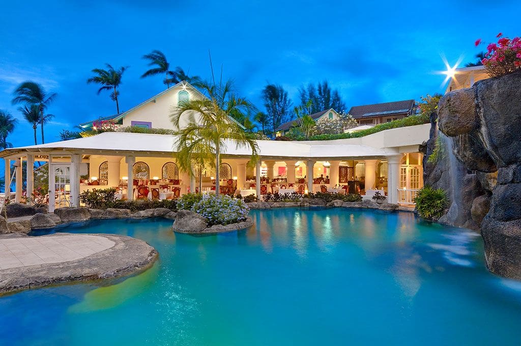 The large pool at Crystal Cove by Elegant Hotels, near the lit-up resort buildings at Crystal Cove by Elegant Hotels.