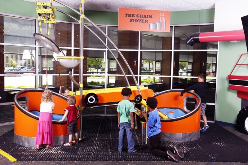 Several young kids play at a colorful exhibit at the Discovery Center Museum, one of the best places in Northern Illinois for families