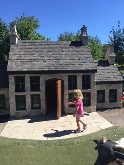 A young girl explore a storybook house at the Bookworm Gardens in Sheboygan.