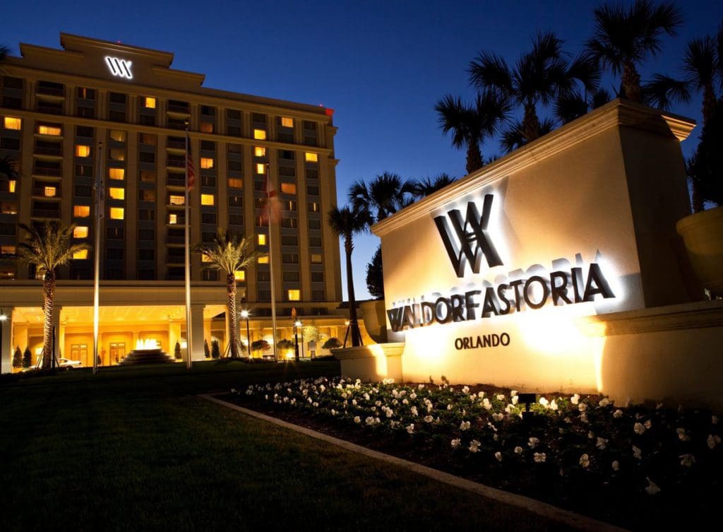 The brightly lit exterior sign and entrance to Waldorf Astoria Orlando.