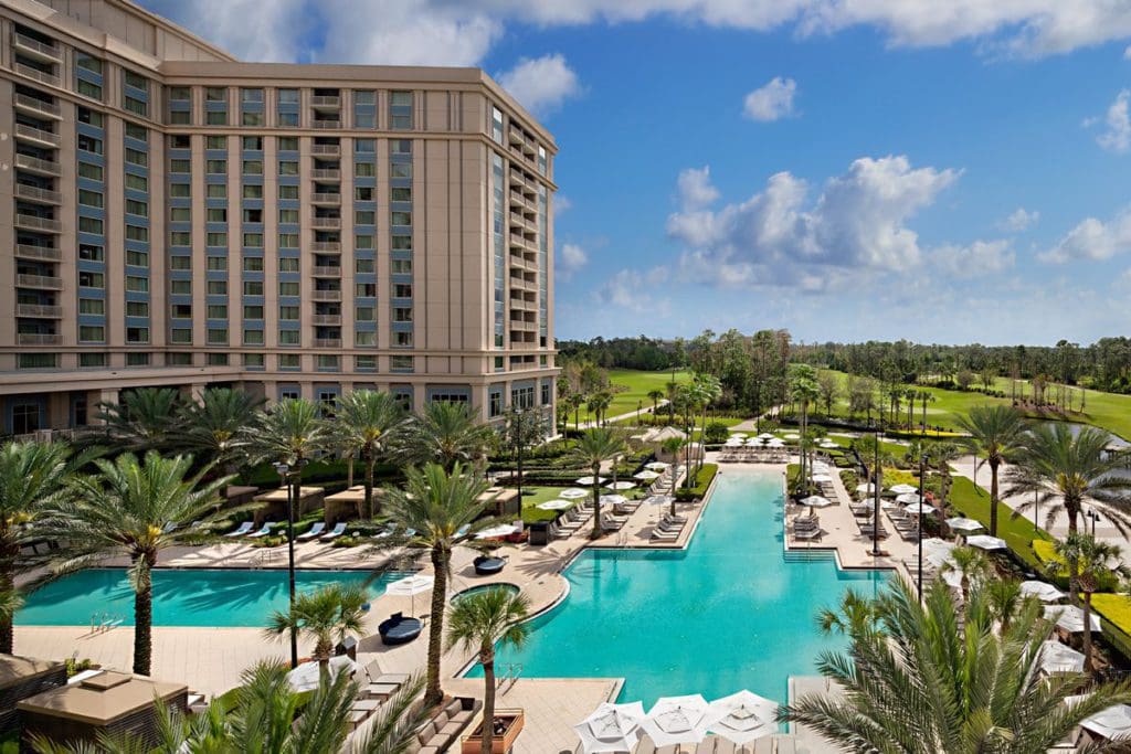 An overhead view of the rear exterior and outdoor pools of the Waldorf Astoria Orlando.