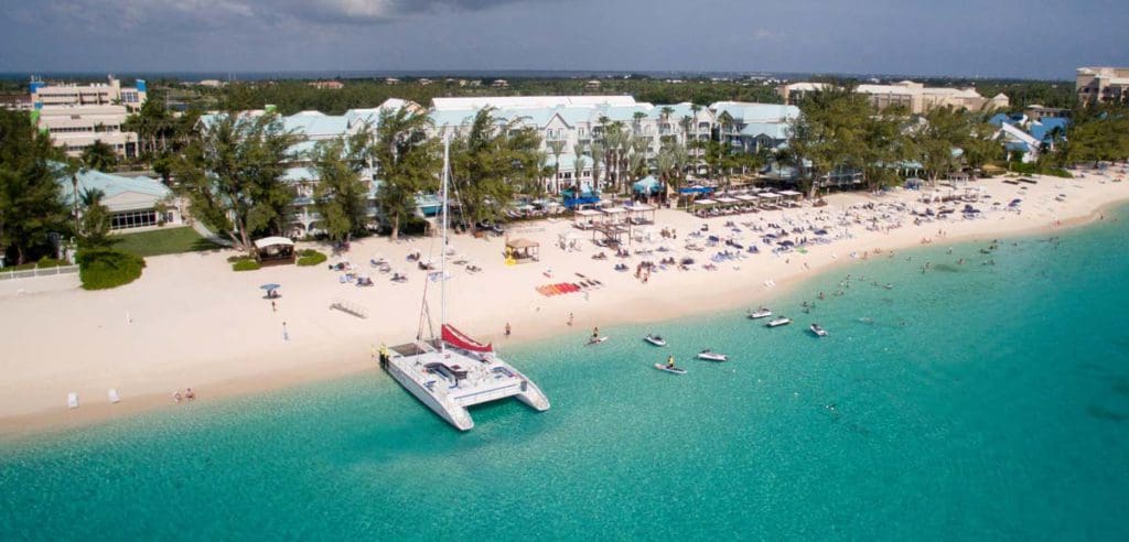 An aerial view of the long stretch of beach and resort shoreline at The Westin Grand Cayman Seven Mile Beach Resort & Spa.