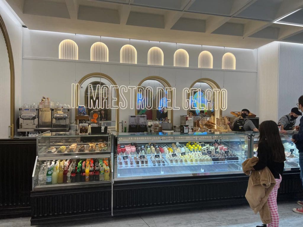 A young girl looks at her gelato options inside a Roman gelateria.