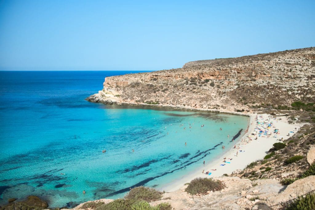 A stretch of coastline in Sicily, featuring a lovely beach and crystal clear waters.