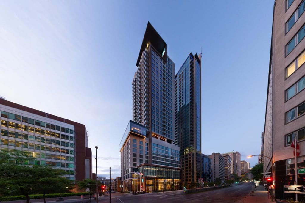 The full exterior of AC Hotel by Marriott Montreal Downtown in its central downtown location.