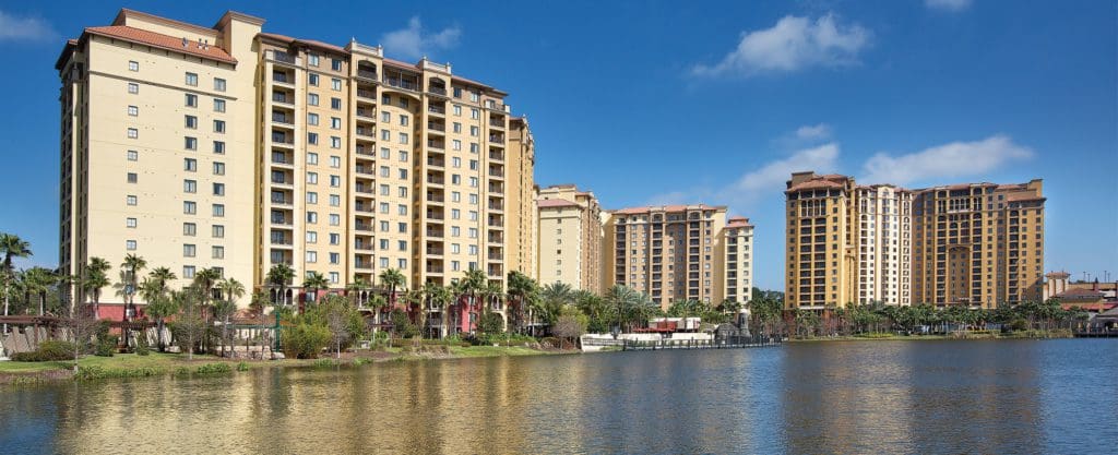 Several large resort buildings for Club Wyndham Bonnet Creek across a large pond.