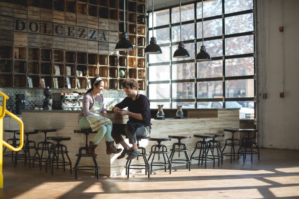 Two people enjoy a scoop of gelato at the counter of Dolcezza, one of the best dessert spots in DC for families.