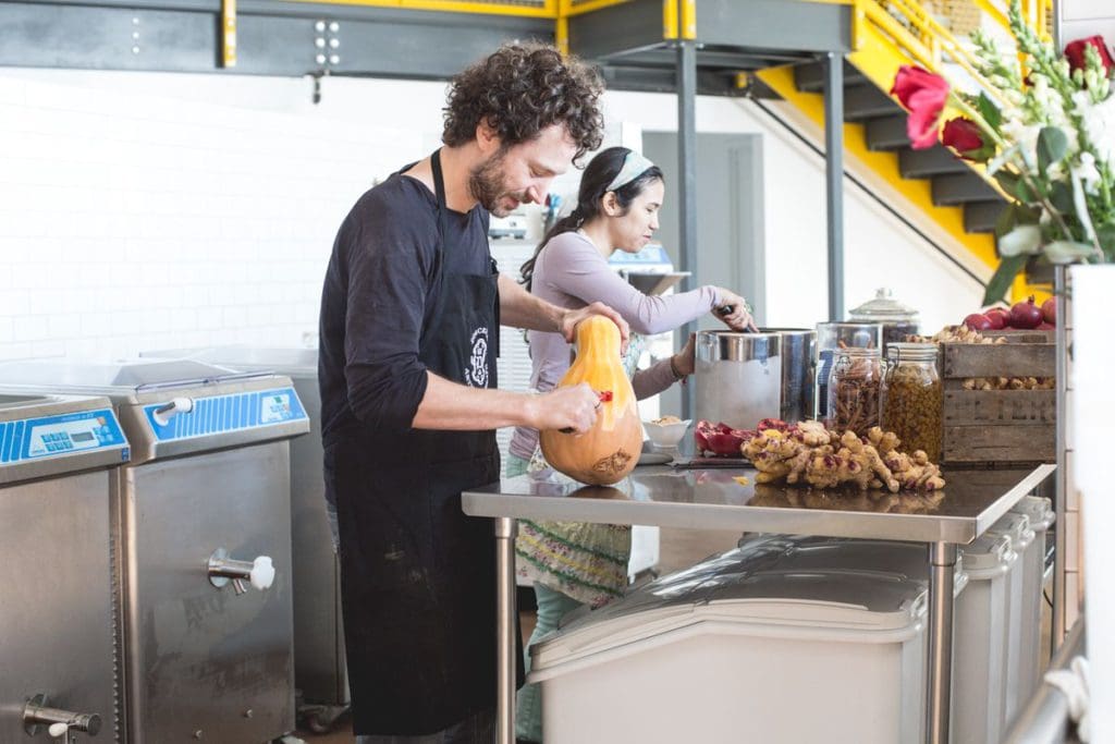 Two staff members make gelato from fresh ingredients at Dolcezza.