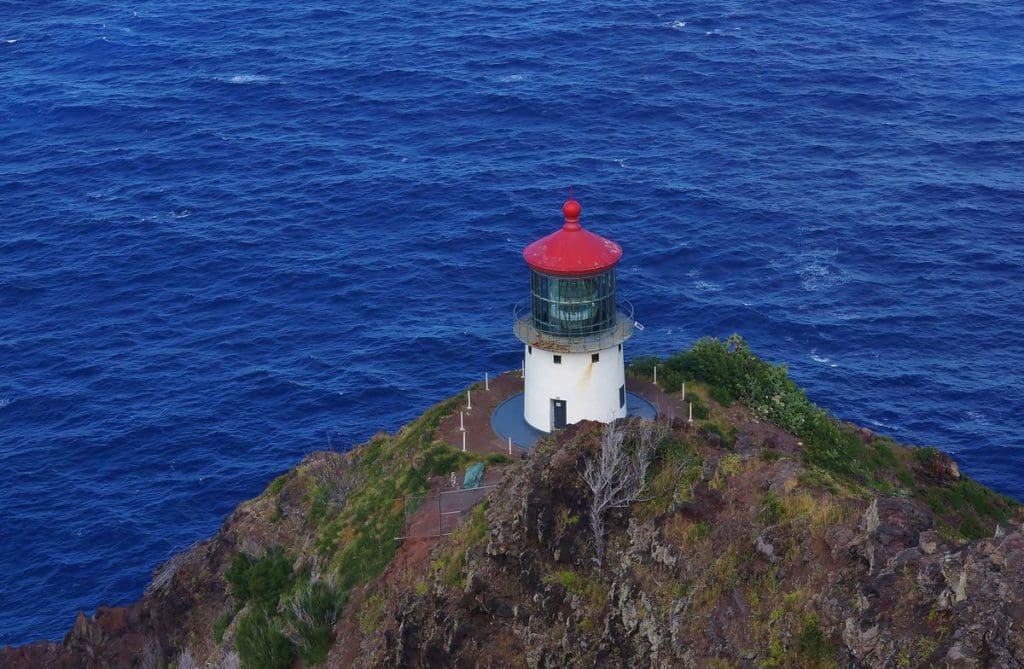 The Makapu'u Point Lighthouse at the edge of a cliff with the ocean beyond in Oahu.