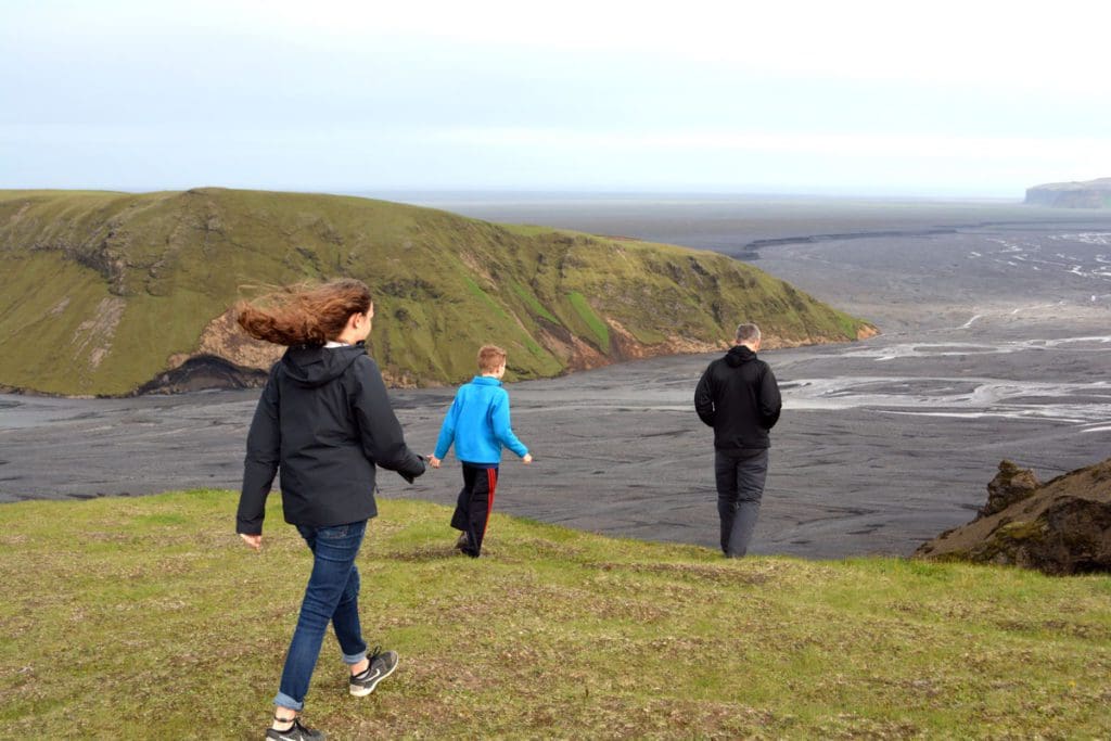 Three kids walk across