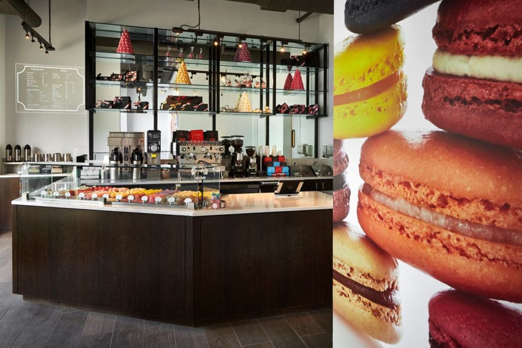 Inside Olivia Macaron, featuring a counter filled with colorful macarons at one of the best dessert spots in DC for families.