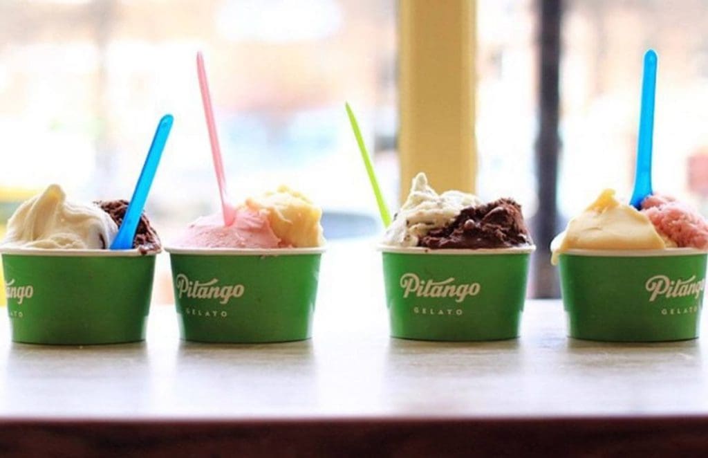 Four cups of gelato from Pitango Gelato rest on the counter waiting to be eaten.